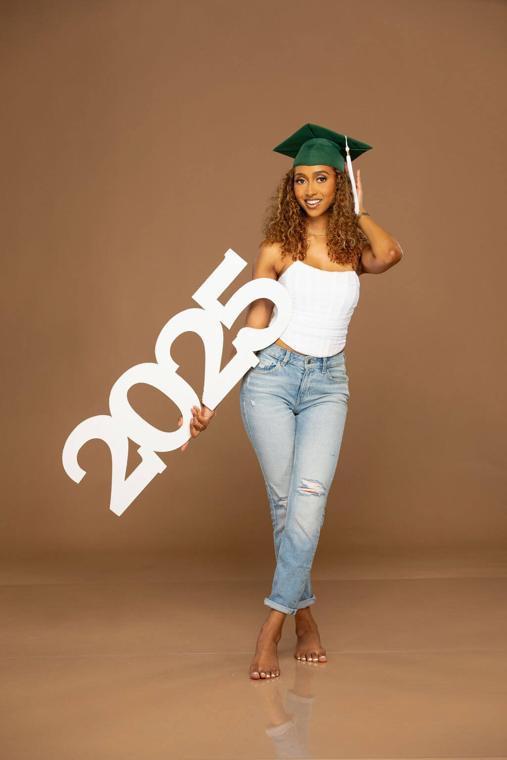 Senior Model holding giant "2025" photo prop!