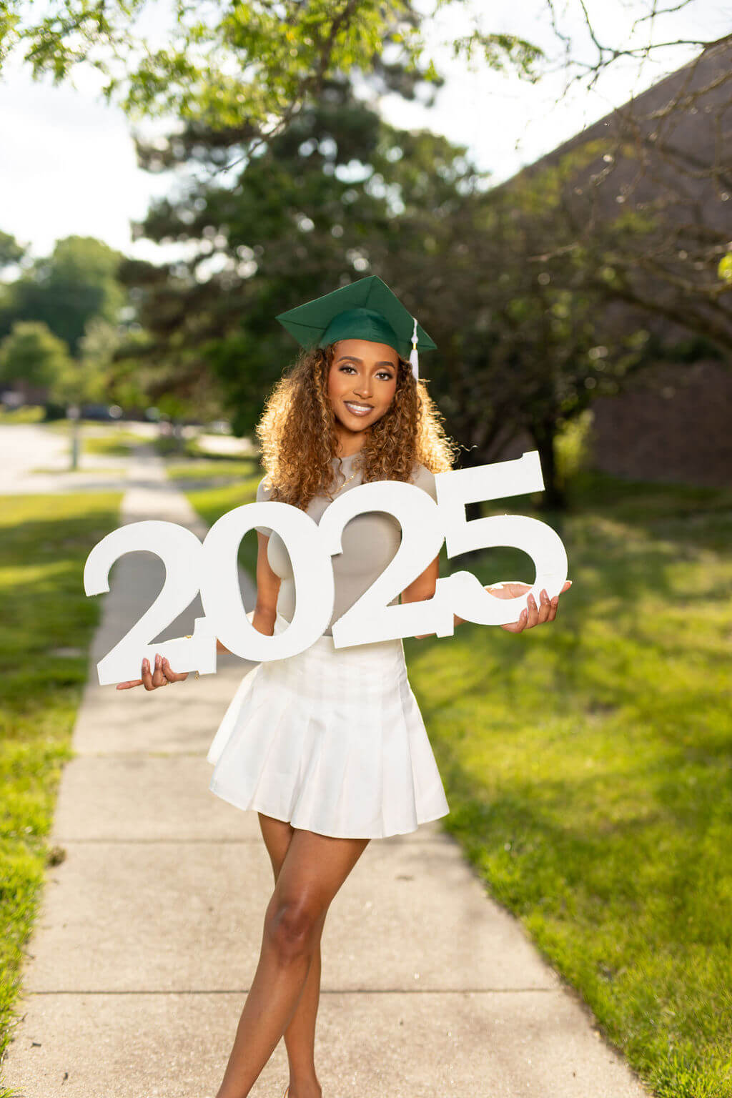 Senior Model holding giant "2025" photo prop!