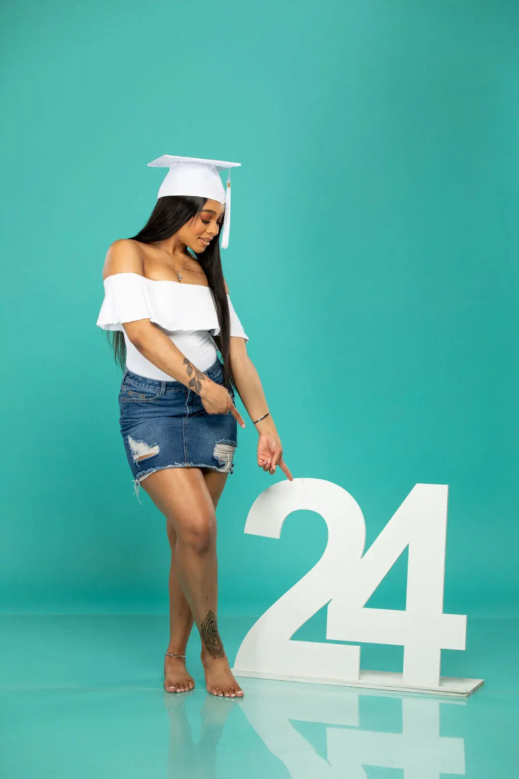 Graduation picture props, 24 wooden prop, beautiful senior pointing at them.