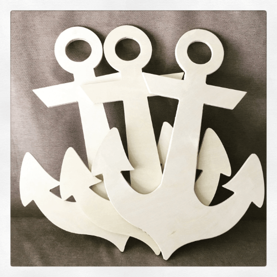 three anchors leaning against a gray/tan background.