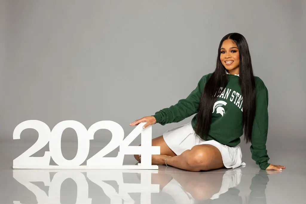 Senior posing props for senior pictures, beautiful girl in Michigan State sweatshirt.