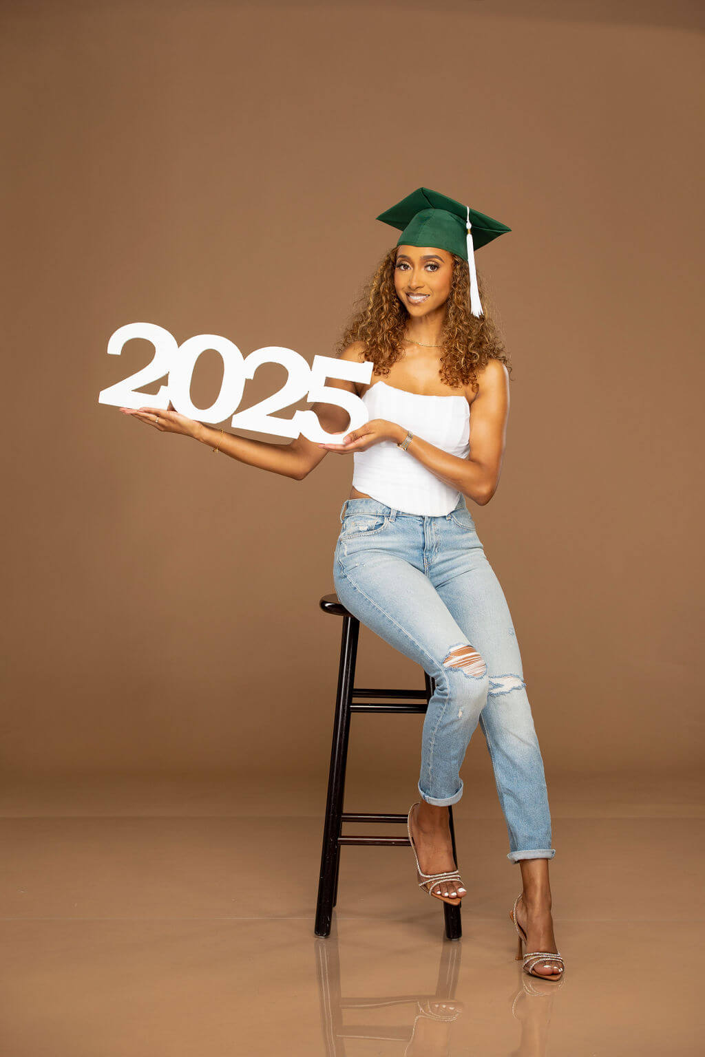 2025 photo prop, held by senior model.