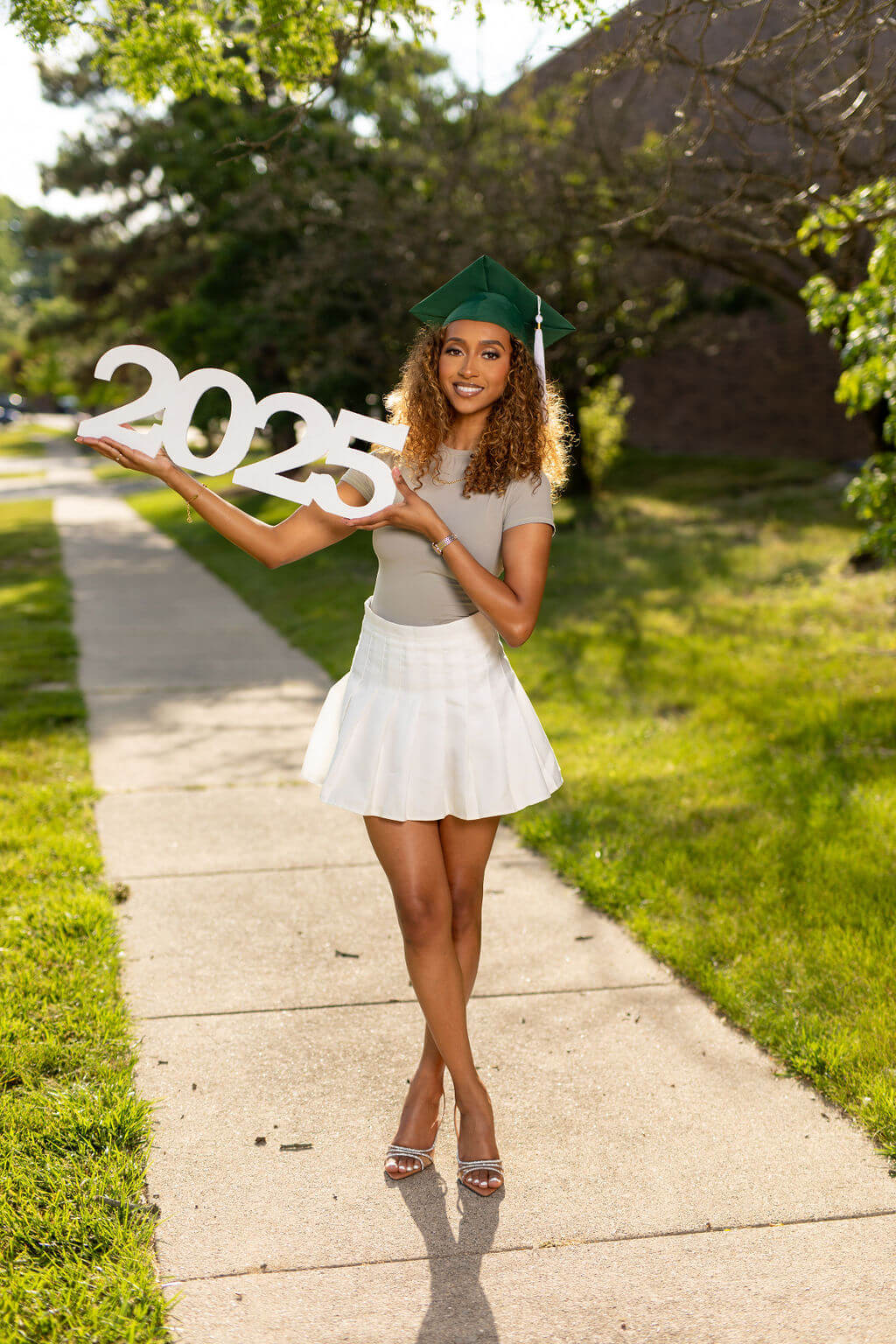 2025 photo prop, held by senior model.