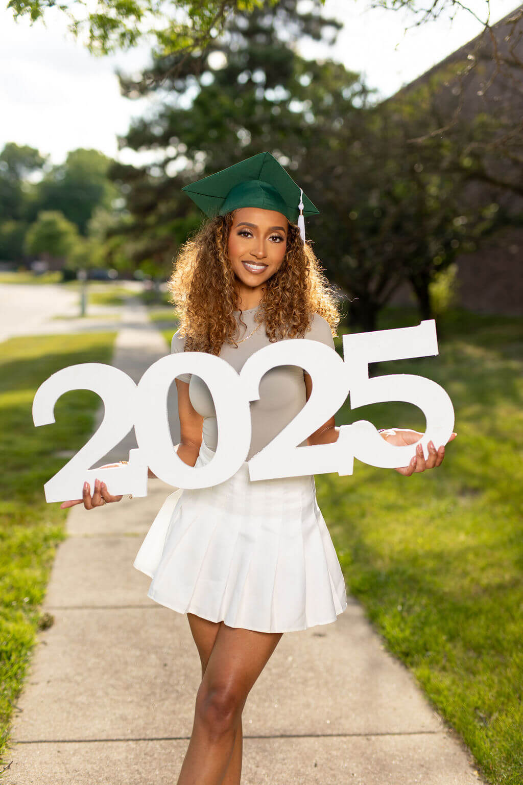 Senior Model holding giant "2025" photo prop!