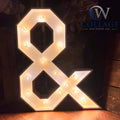 Amp up your event with this enchanting marquee light up ampersand, standing 3 feet tall. Crafted from premium wood and adorned with energy-efficient LED lights, it's the perfect addition to any celebration. Available at collageandwood.com.
