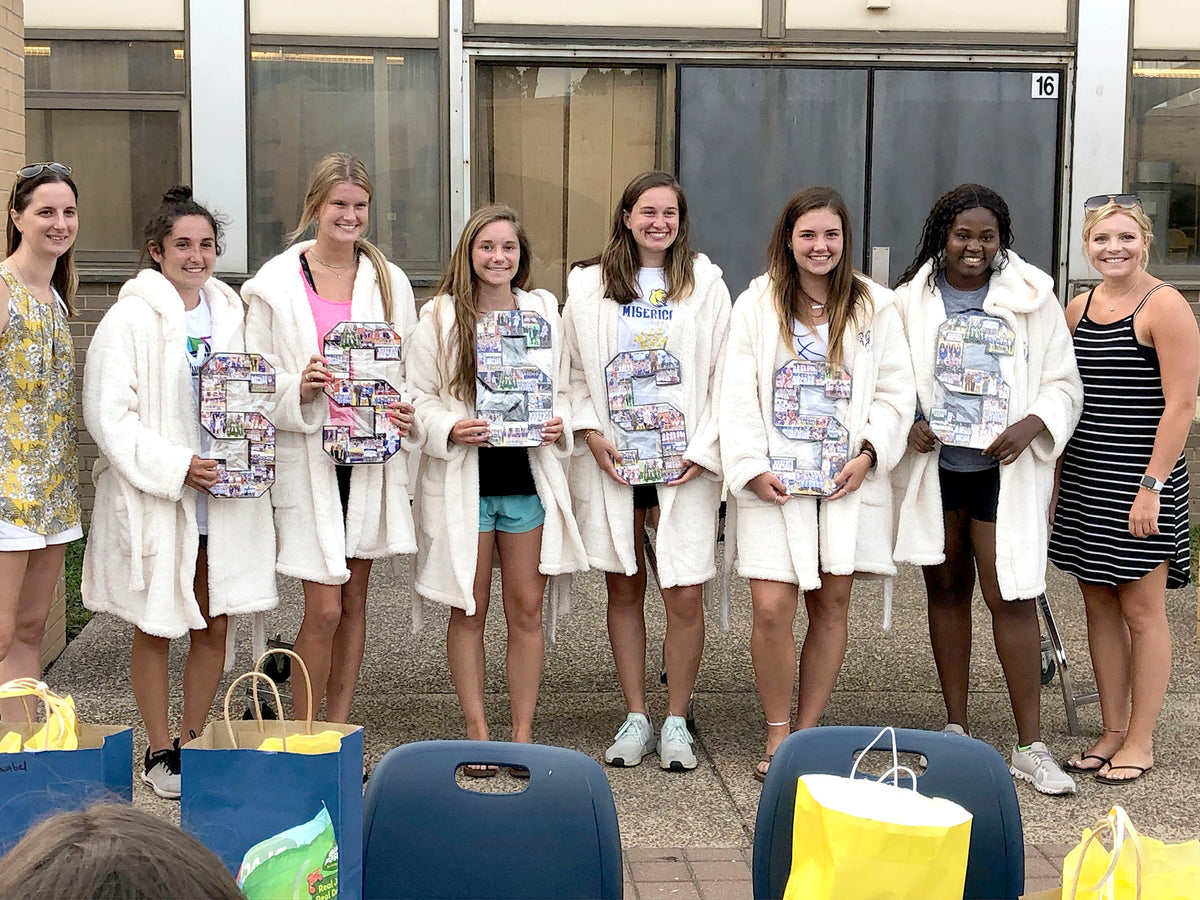 Senior basketball team with their collage letter gifts after senior night.