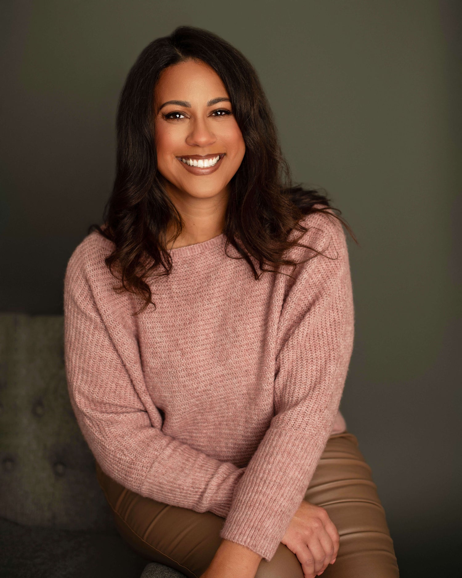 Crystal Waddell headshot, pink sweater.