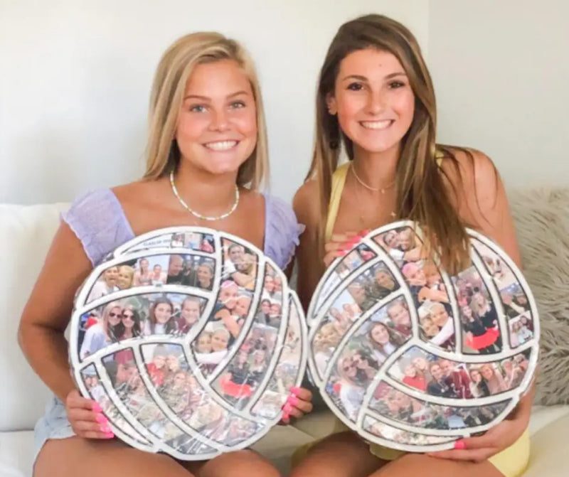 Two volleyball players holding wooden volleyball-shaped photo collages