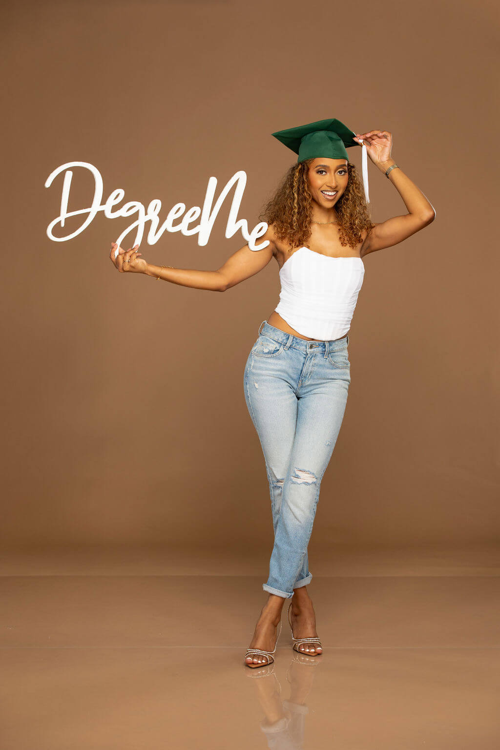 Degree Me Photo Prop, Held by senior model in grad cap.