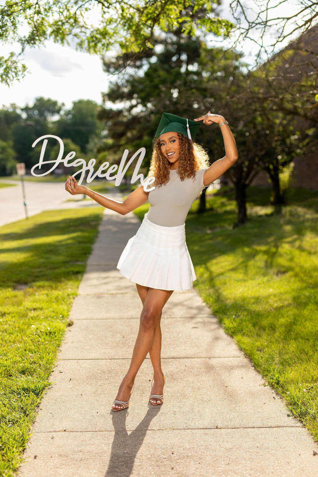 Degree Me Photo Prop, Held by senior model in grad cap.