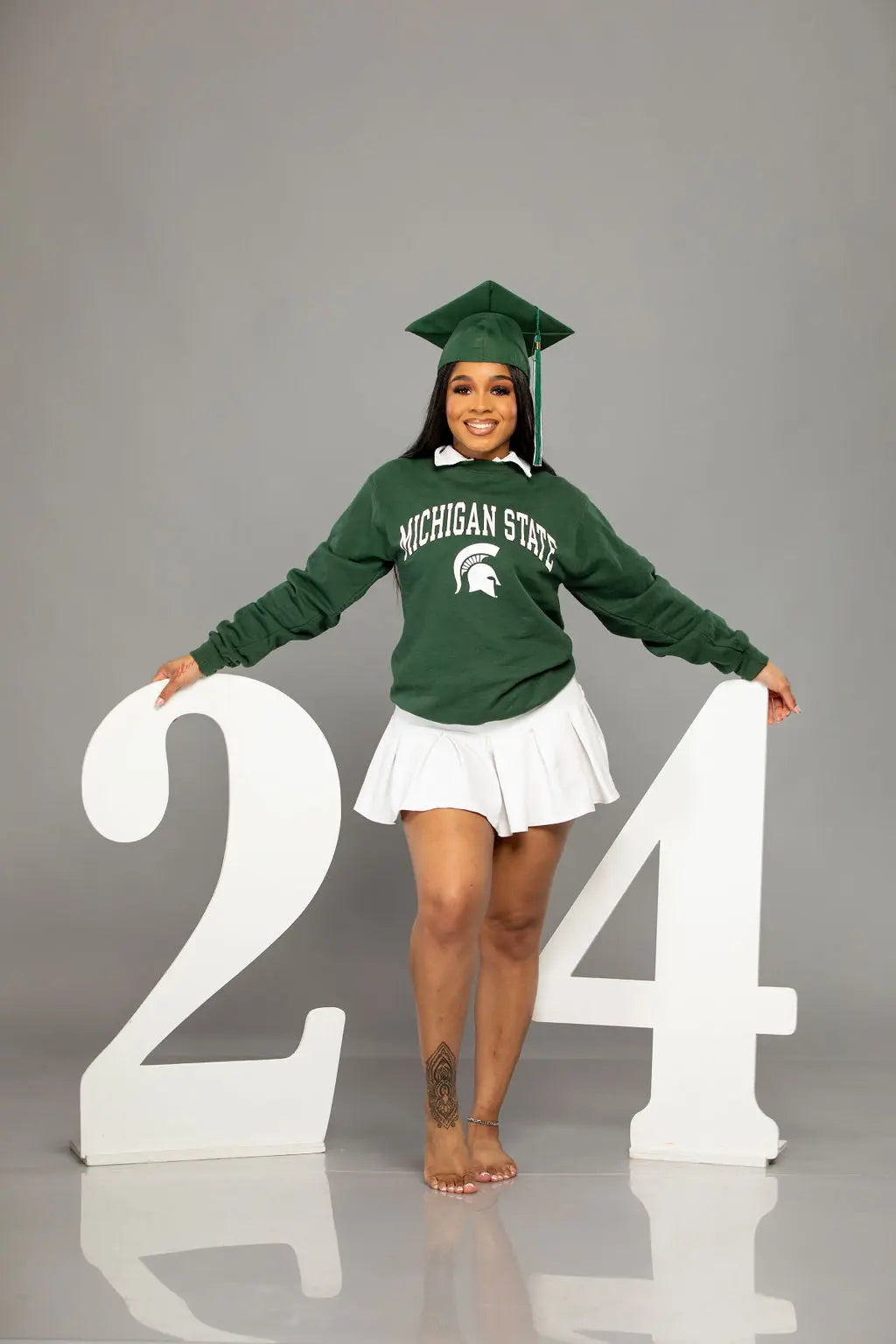 Proud 2024 graduate with 2024 graduation photo props.