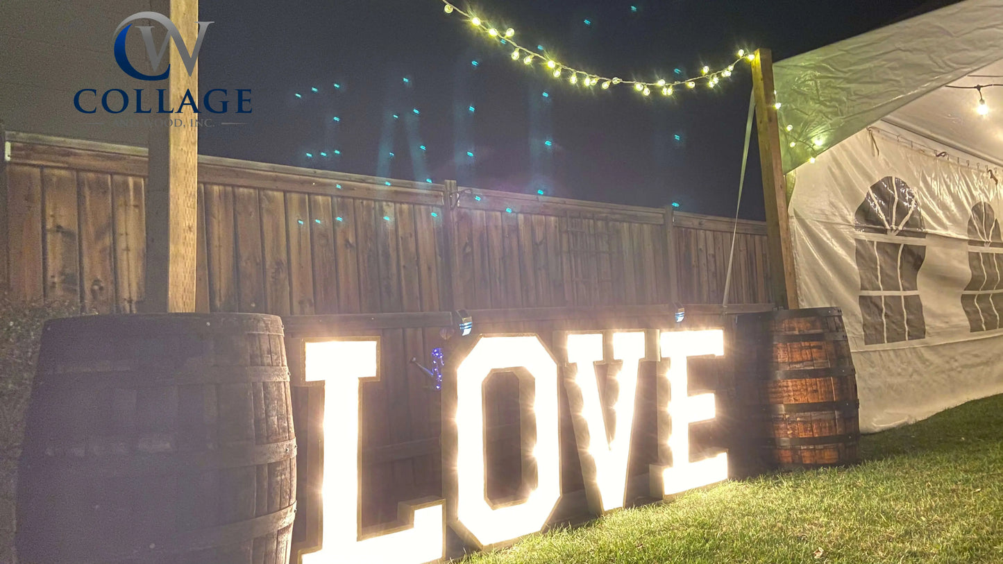 Lively wooden marquee spelling LOVE, standing 3 feet tall in a pristine white finish, brilliantly lit by battery-powered LED lights.