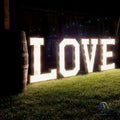 Lively 3ft marquee light up letters spelling LOVE, the perfect centerpiece for weddings, anniversaries, and romantic celebrations. Brilliantly lit by battery-powered LED lights. Available at collageandwood.com.