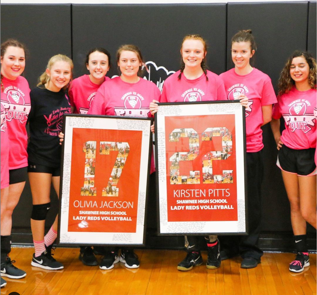 Volleyball Team with two seniors holding their senior night posters from collageandwood.com #17 and #22.