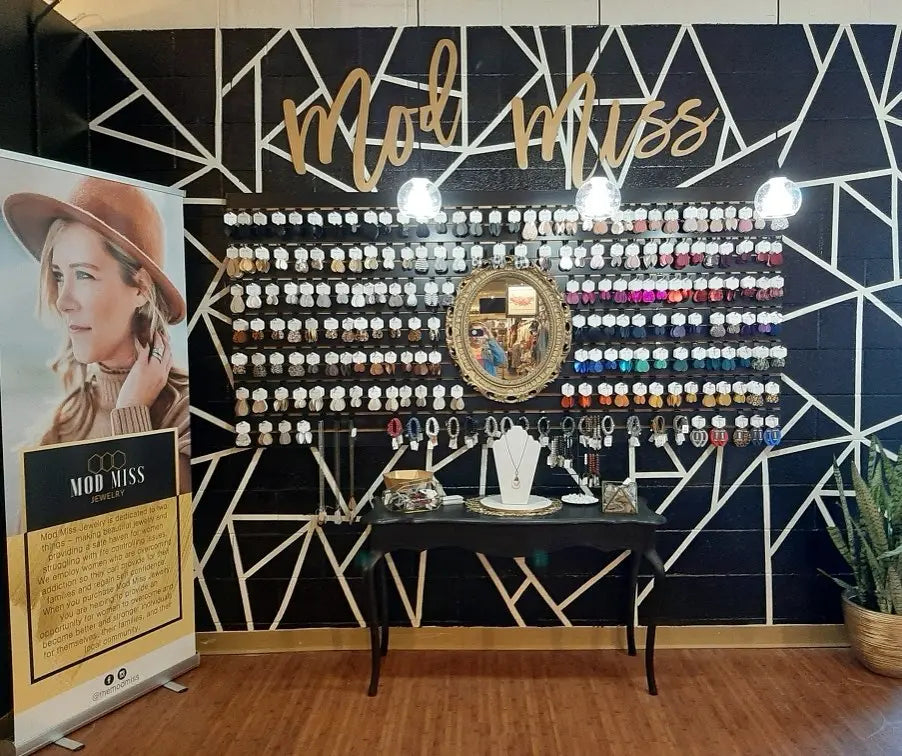 Mod Miss wall lettering on black wall.